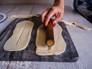 Biang Biang Noodles - Pressing the rolling pin against the rolled out dough