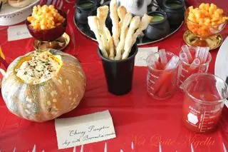 Pumpkin cheese dip with puff pastry witches' broomsticks